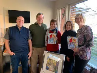 Group of people holding the book